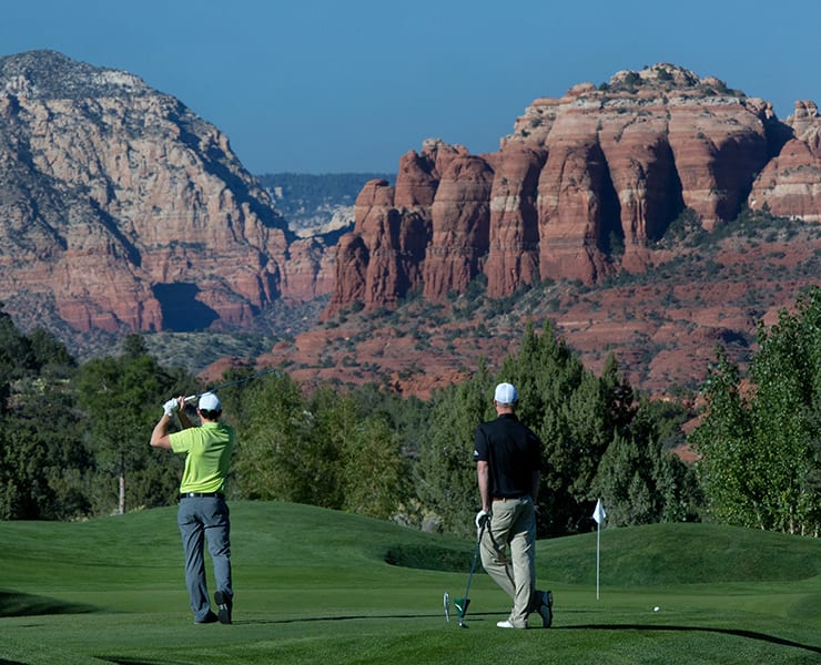 Golfers on the 10th hole of the Sedona Golf Resort with Catheral Rock in the backgound