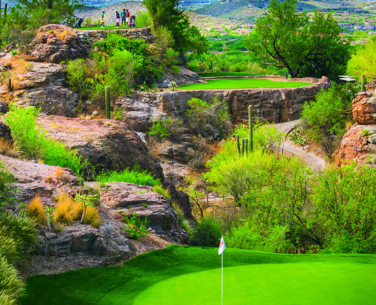 Golfers on the third hole which overlooks the green at The Lodge at Ventana Canyon