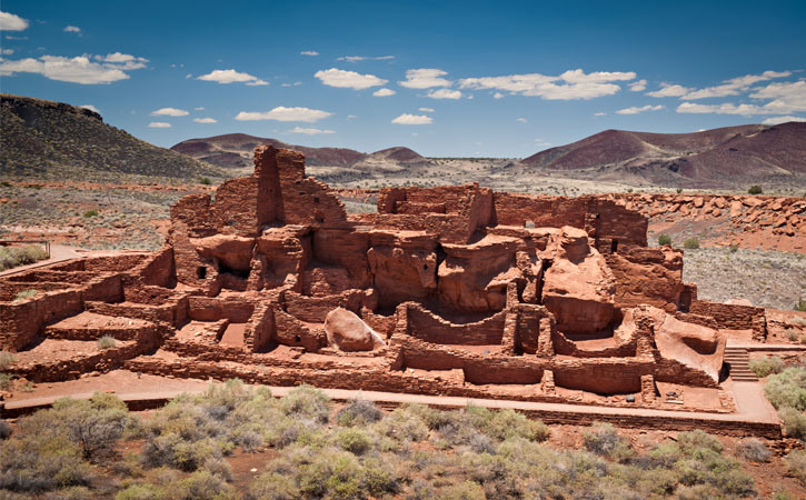 Ancient indigenous ruins stand against a desert landscape